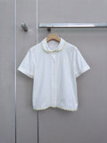 Lace-trimmed short white shirt