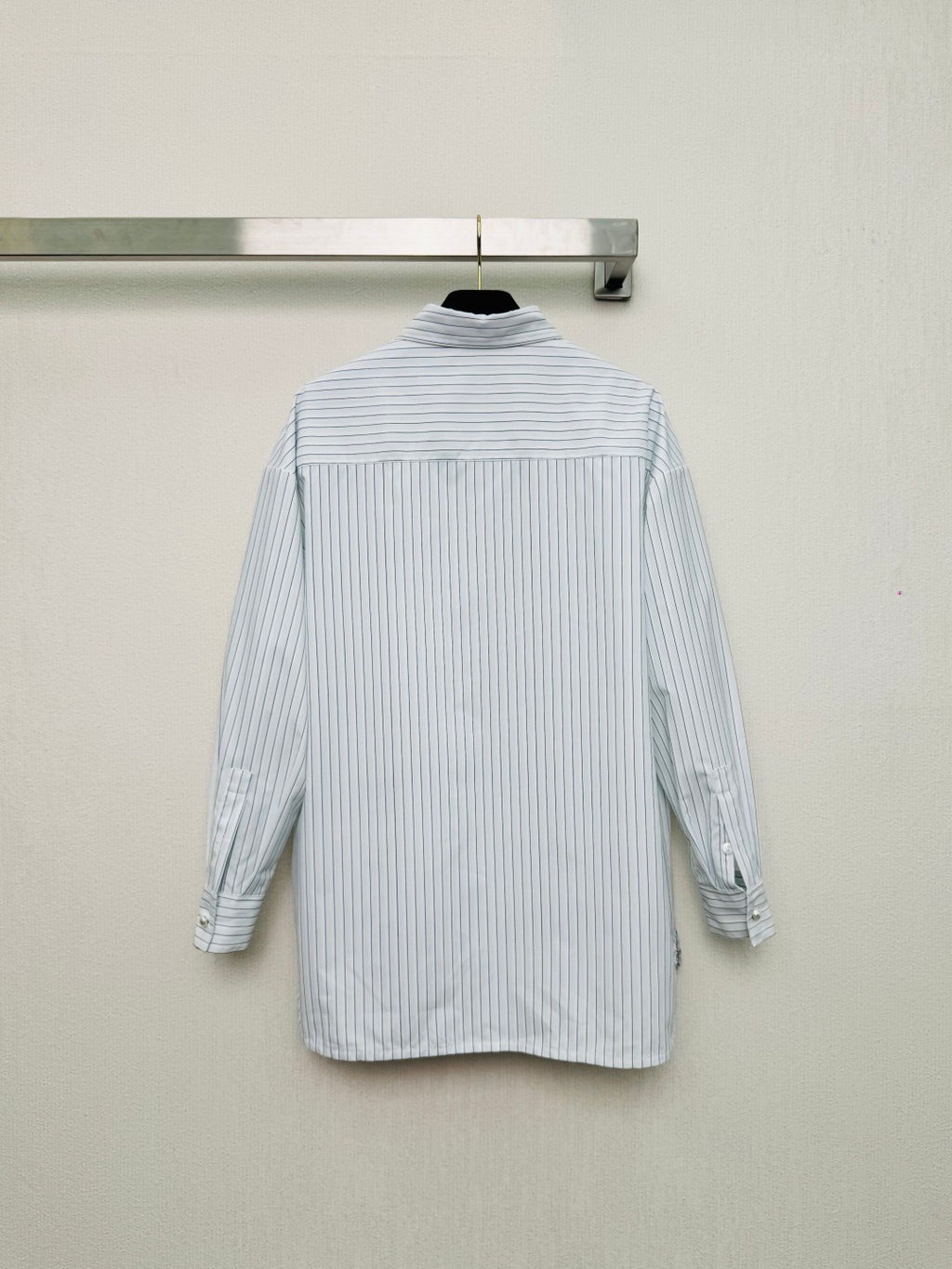 Striped shirt from the Spring/Summer 2026 collection, featuring a blue and white vertical stripe design, fresh and simple.