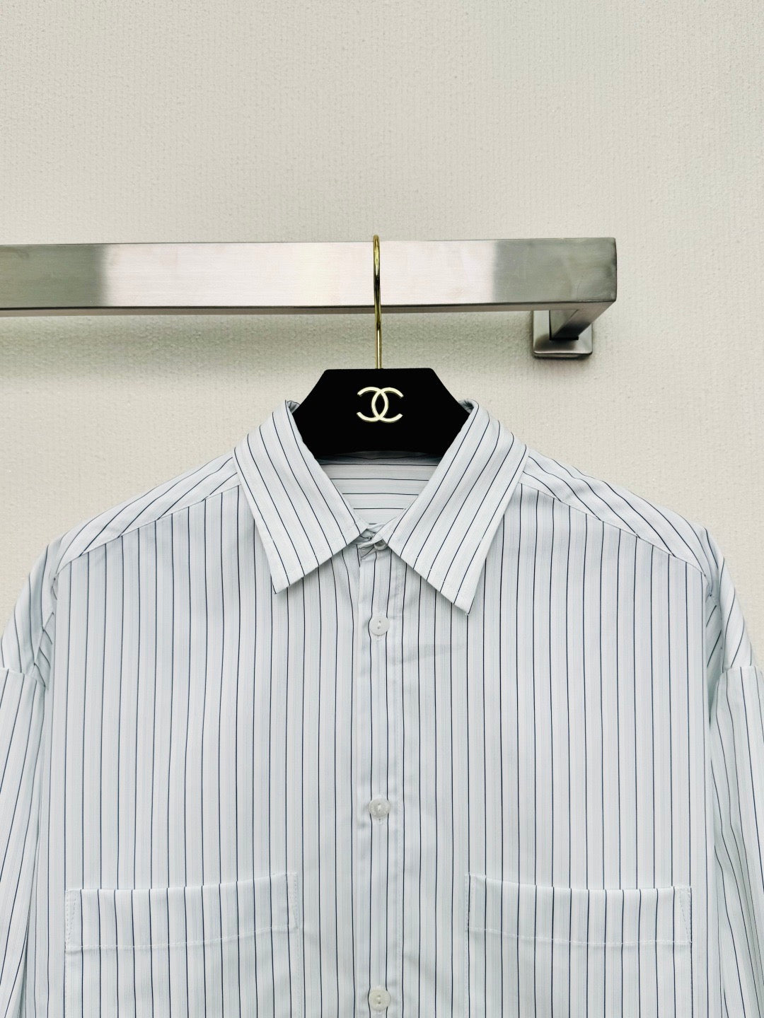Striped shirt from the Spring/Summer 2026 collection, featuring a blue and white vertical stripe design, fresh and simple.