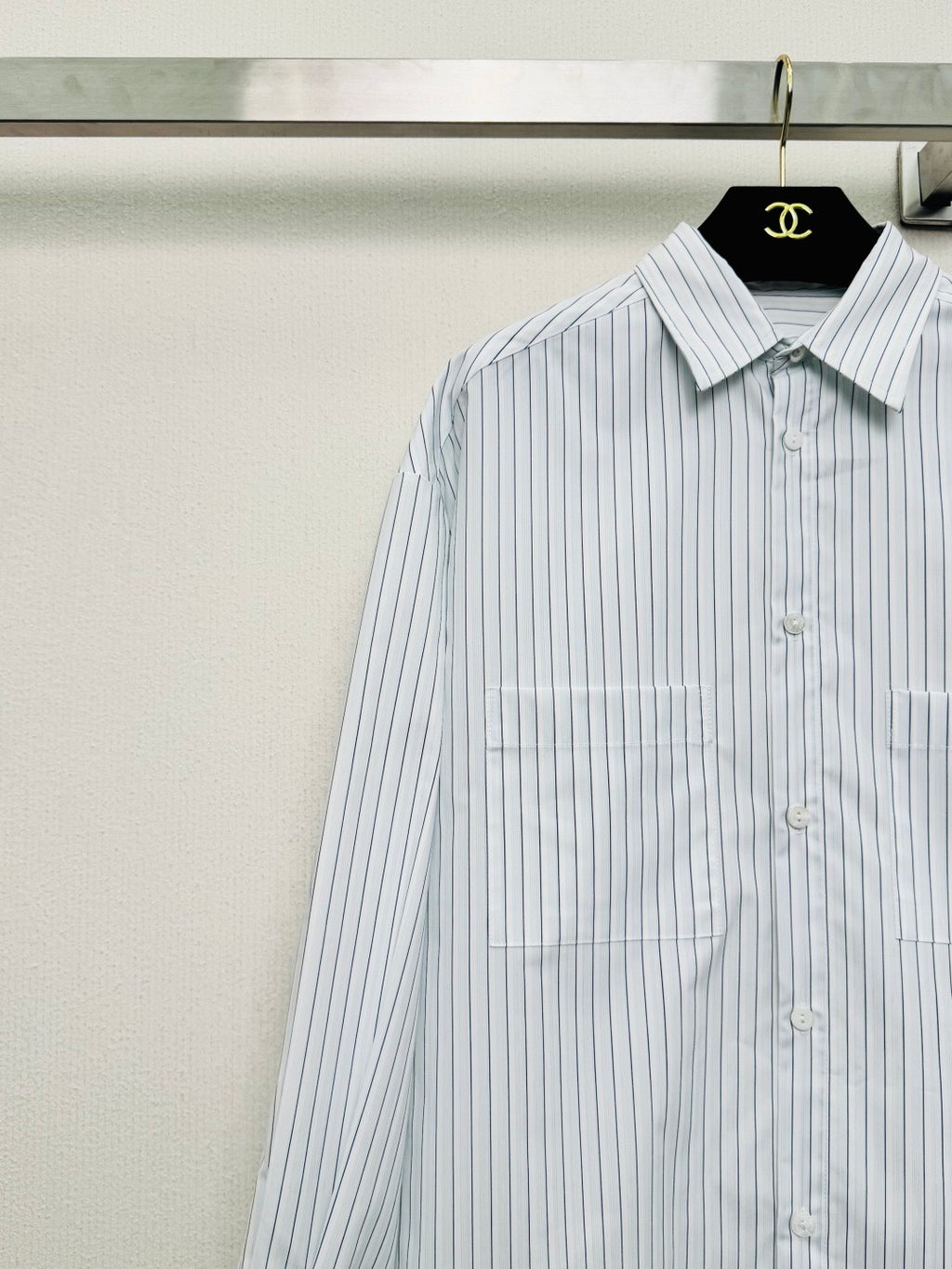 Striped shirt from the Spring/Summer 2026 collection, featuring a blue and white vertical stripe design, fresh and simple.