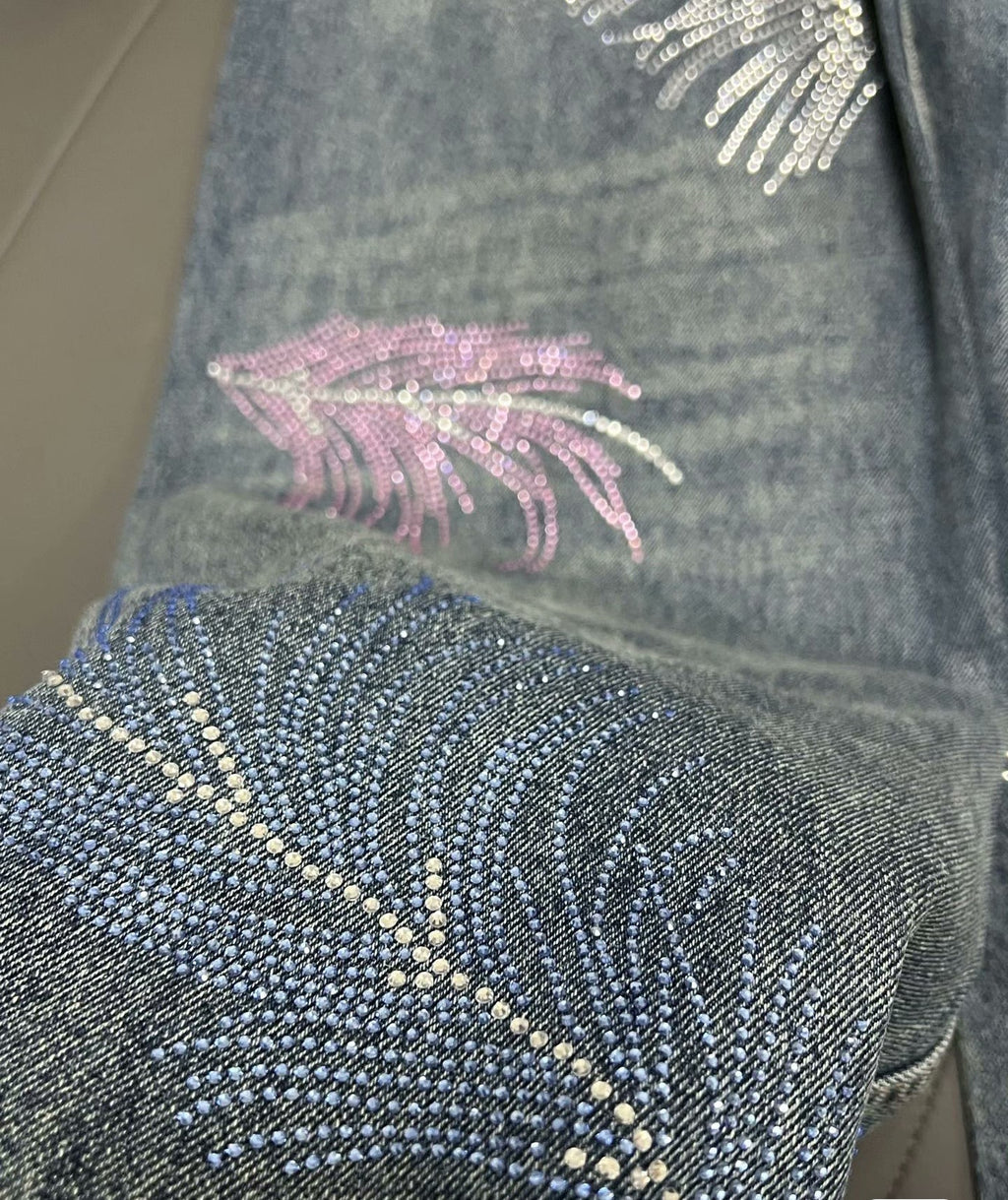 2026 Feather & Rhinestone Jeans: Featuring a high-waisted, wide-leg silhouette crafted from blue denim, with a unique feather and rhinestone embellishment design.