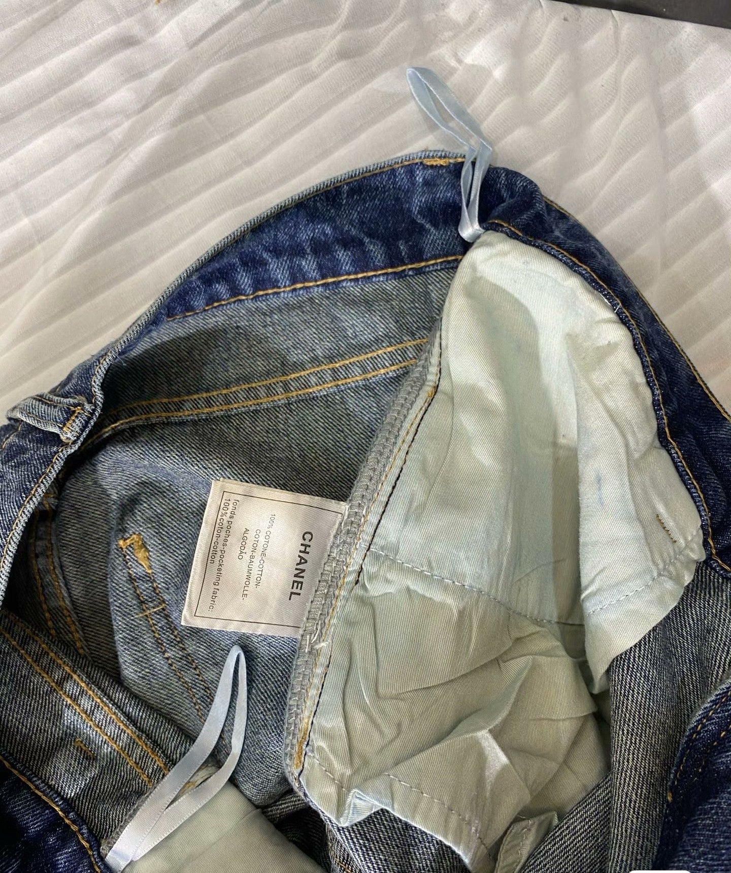 2026 Feather & Rhinestone Jeans: Featuring a high-waisted, wide-leg silhouette crafted from blue denim, with a unique feather and rhinestone embellishment design.