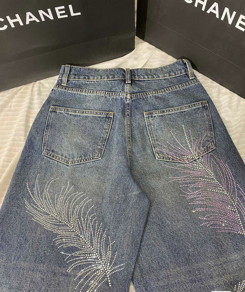 2026 Feather & Rhinestone Jeans: Featuring a high-waisted, wide-leg silhouette crafted from blue denim, with a unique feather and rhinestone embellishment design.