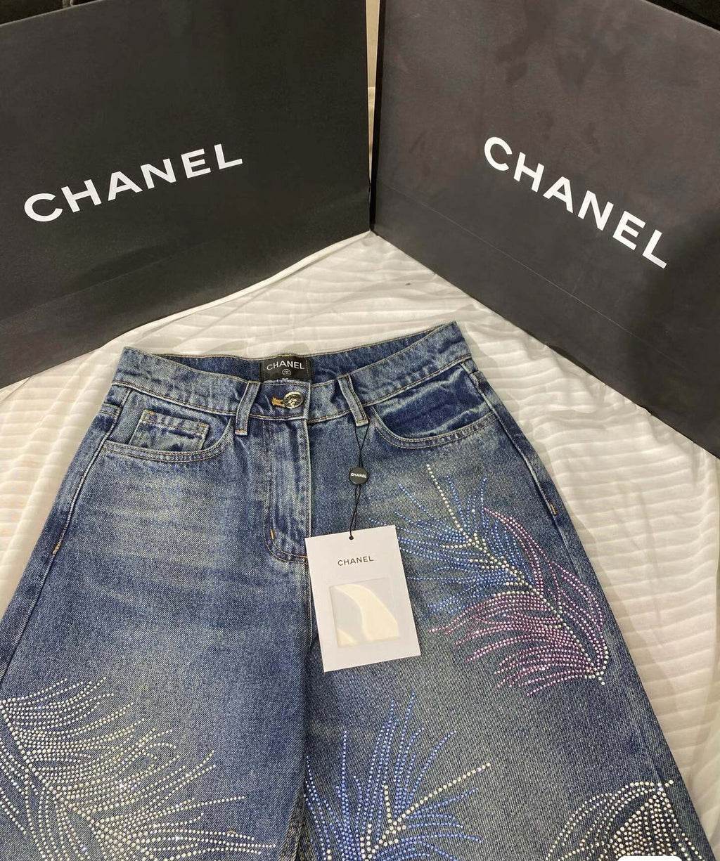 2026 Feather & Rhinestone Jeans: Featuring a high-waisted, wide-leg silhouette crafted from blue denim, with a unique feather and rhinestone embellishment design.