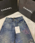 2026 Feather & Rhinestone Jeans: Featuring a high-waisted, wide-leg silhouette crafted from blue denim, with a unique feather and rhinestone embellishment design.