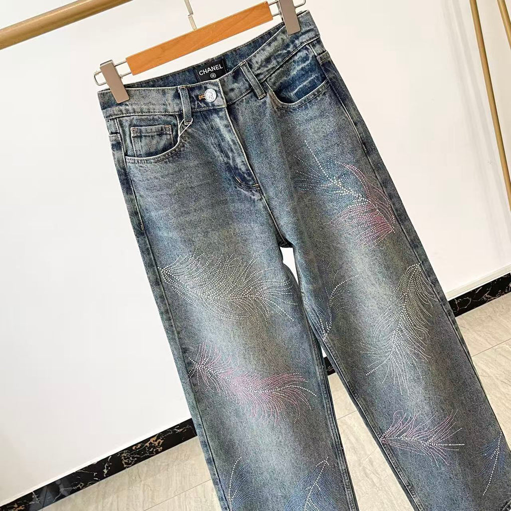 2026 Feather & Rhinestone Jeans: Featuring a high-waisted, wide-leg silhouette crafted from blue denim, with a unique feather and rhinestone embellishment design.