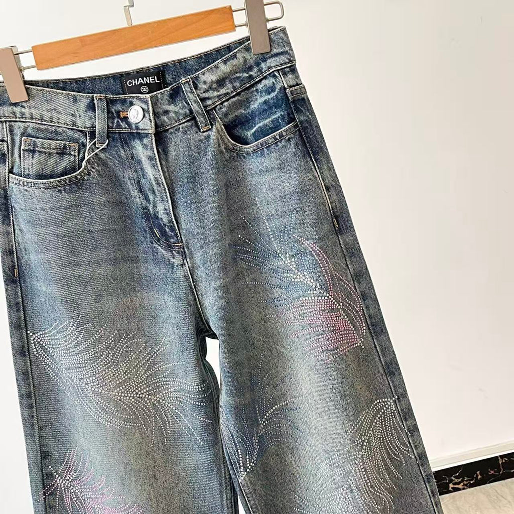 2026 Feather & Rhinestone Jeans: Featuring a high-waisted, wide-leg silhouette crafted from blue denim, with a unique feather and rhinestone embellishment design.