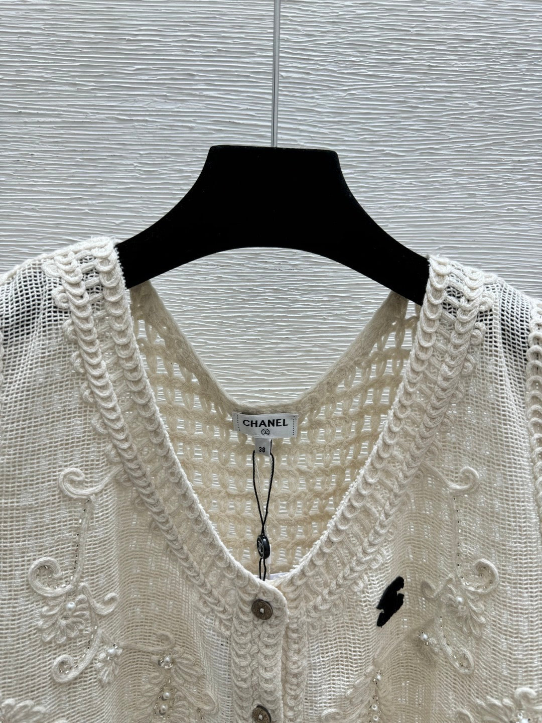 2026 New Arrival: Sleeveless V-Neck Knit Top in Apricot — Featuring Openwork Logo Pattern, Pearl Embroidery, and Single-Breasted Design