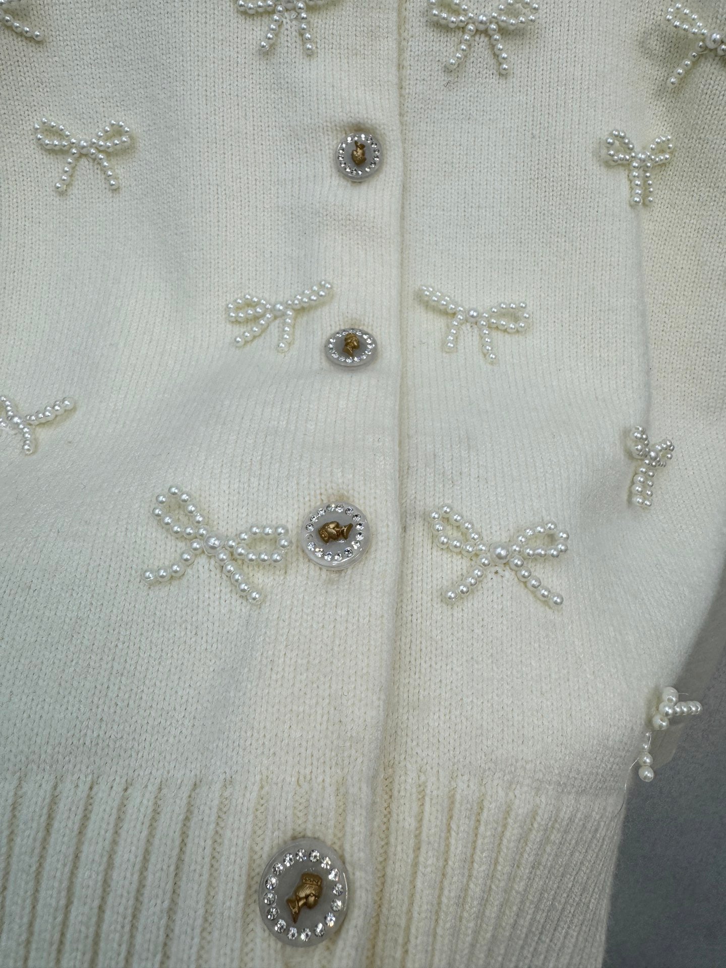 2026 New Arrival: Handcrafted Pearl & Bow-Knot Knitted Cardigan — Featuring Purely Hand-Beaded Bow-Knot Embellishments and Diamond-Style Buttons.