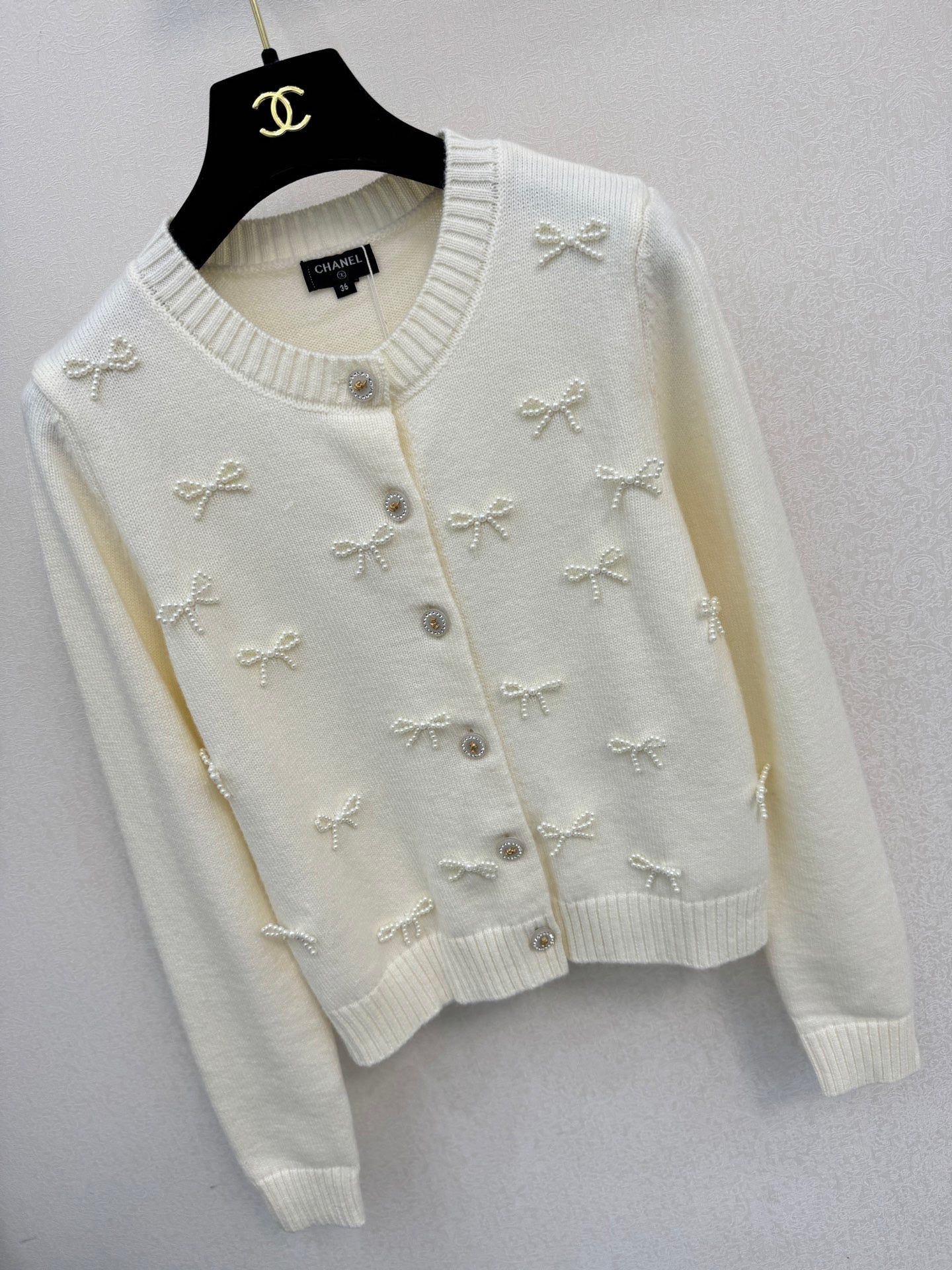 2026 New Arrival: Handcrafted Pearl & Bow-Knot Knitted Cardigan — Featuring Purely Hand-Beaded Bow-Knot Embellishments and Diamond-Style Buttons.